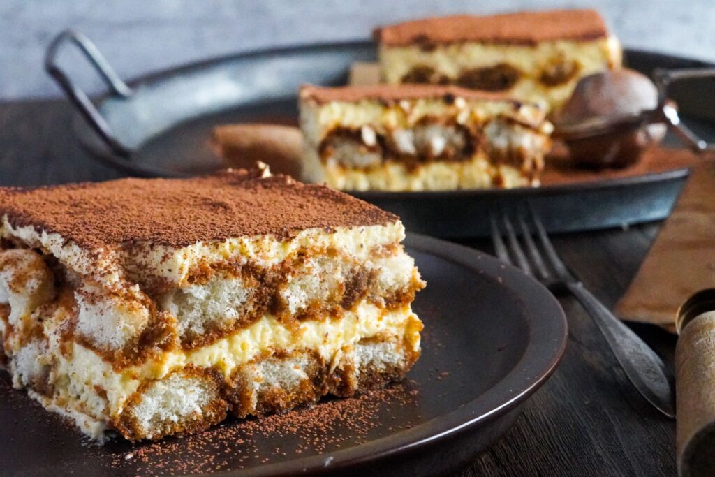 Italian tiramisu made up of yummy cream-embracing spongy coffee-soaked ladyfingers