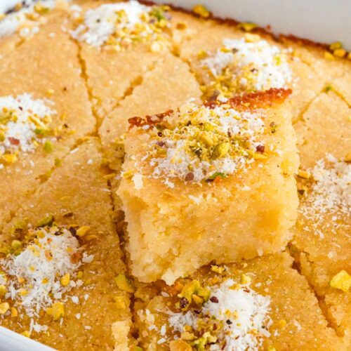 Basbousa is a mouthwatering Middle Eastern dessert cherished for its unique blend of textures and sweet flavors. It's primarily composed of semolina, sugar, and yogurt, creating a tender yet crumbly cake. What sets Basbousa apart is its aromatic syrup infusion, making it a delightful treat soaked in sugary bliss.