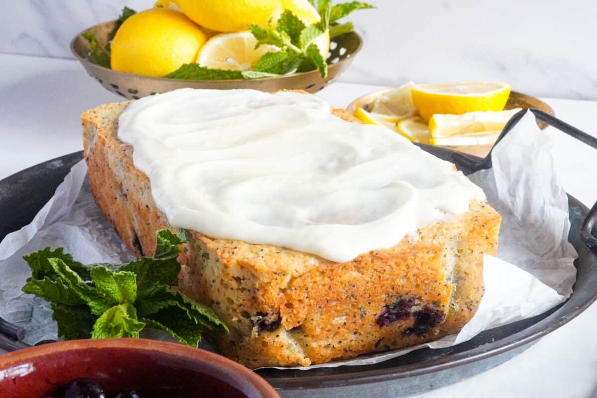 A blueberry loaf cake covered with lemon glaze syrup. 
