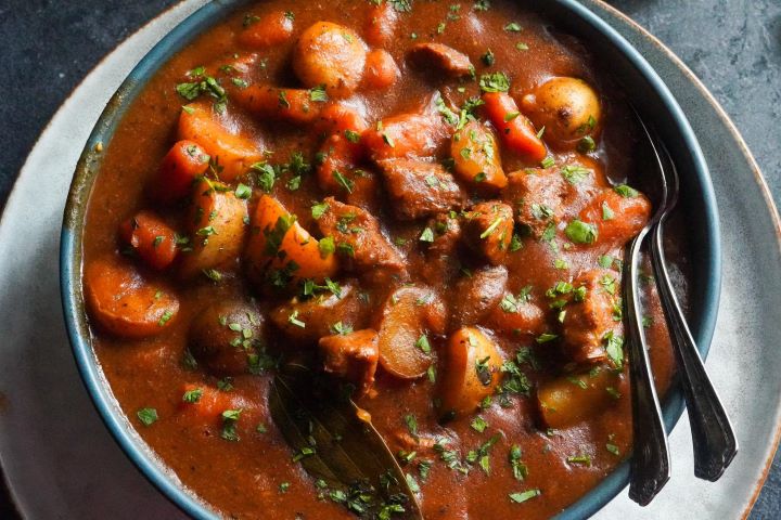 This easy beef stew recipe features baby potatoes, large carrots, and beef chunks in a broth with tomato paste.