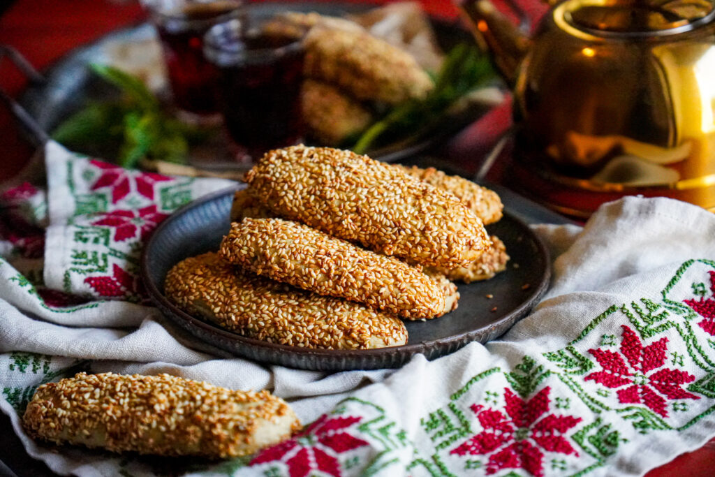 Palestinian Sesame Tea cookies is a very simple and quick recipe that combines flour, fennel, ghee, delicious sesame seeds and topped with simple syrup or honey. One cookie won't be enough!