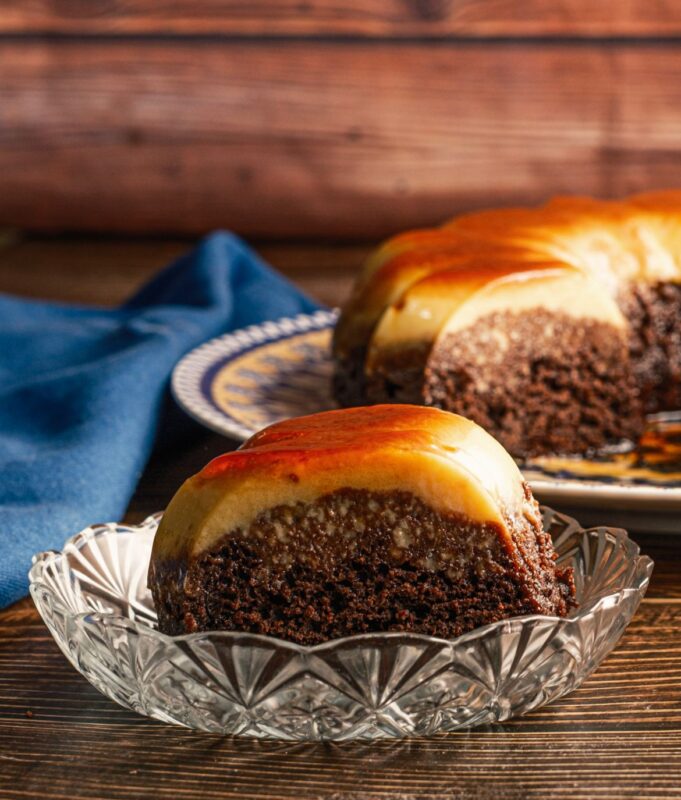 a slice of indulgent kudret kadir cake with rich cocoa and sweetened condensed milk topped with a drizzle of caramel