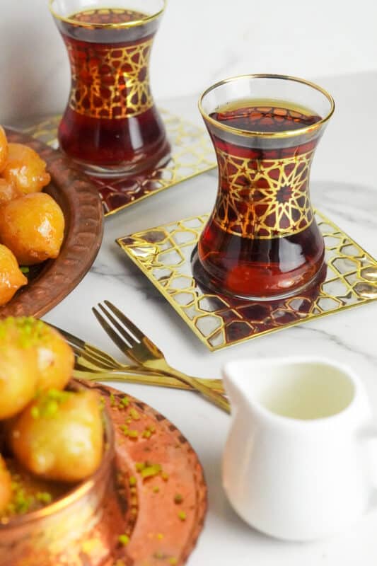 puffed-up, crispy, fried finger-licking awameh served with cups of Middle Eastern mint tea to enjoy them with friends and family