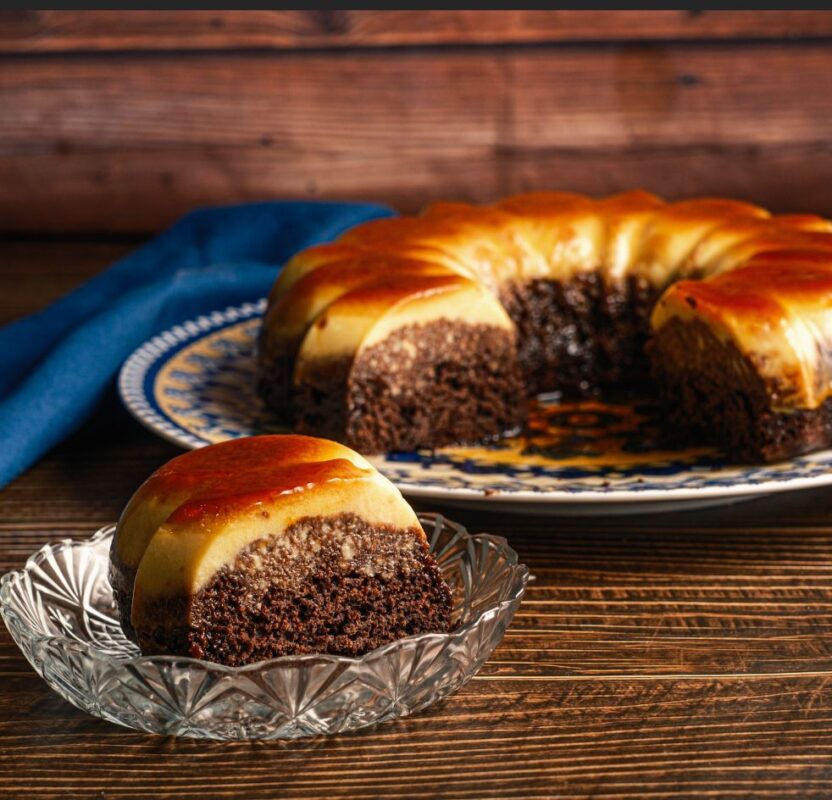 moist chocolate cake topped with a smooth creamy layer of flan, and a glossy caramel glaze