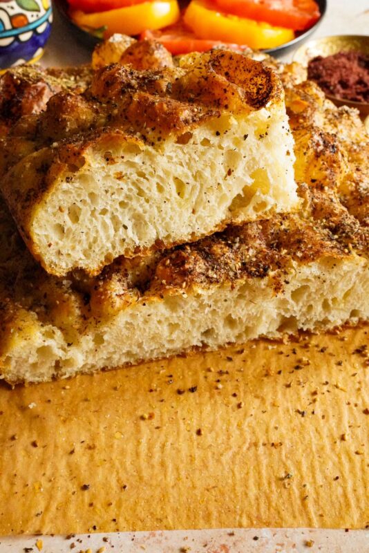 A soft and fluffy pieces of focaccia bread topped with zaatar and sumac.