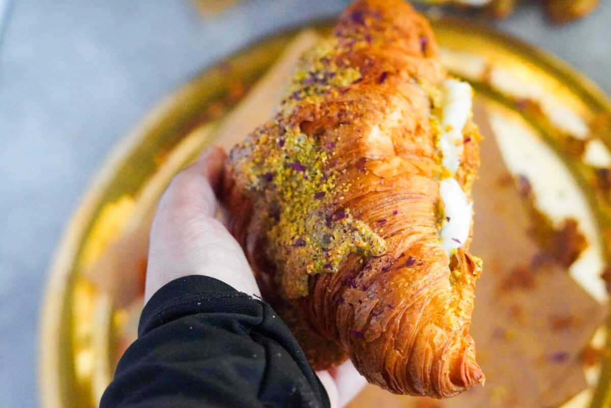 A large croissant filled with pistachio paste and ashta