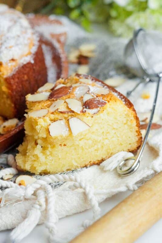 A slice of almond cake with a fluffy and moist texture