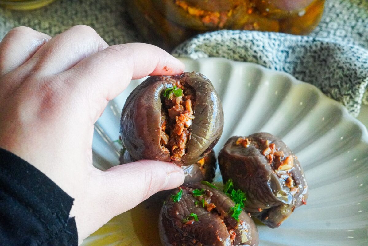 a plate of middle eastern stuffed eggplants pickles sprinkled with finely chopped parsley.