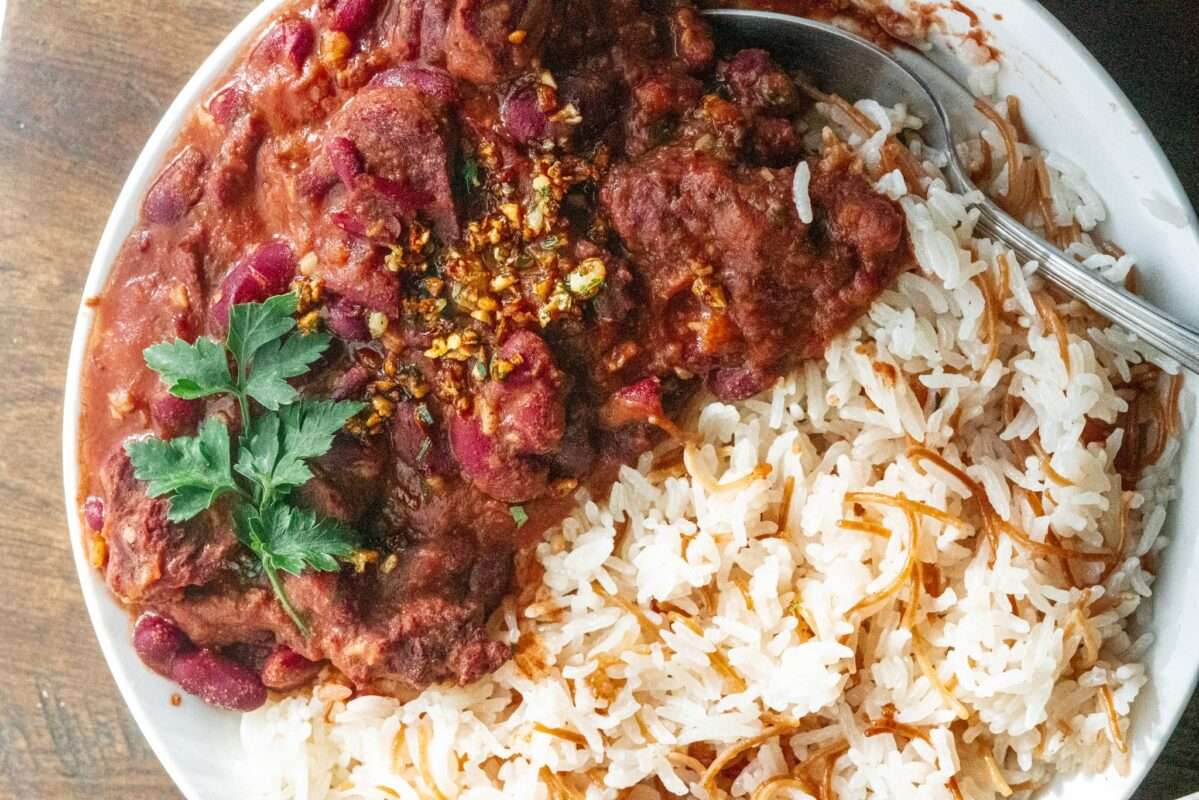 Delicious plate layered with juicy tomato sauce, with rice on the side, topped with parsley 
