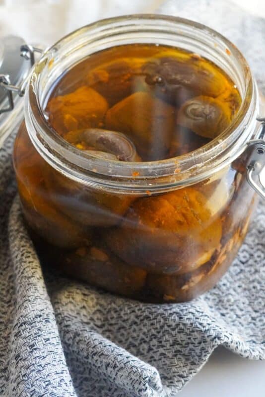 a jar of middle eastern stuffed makdous pickles in olive oil to cover