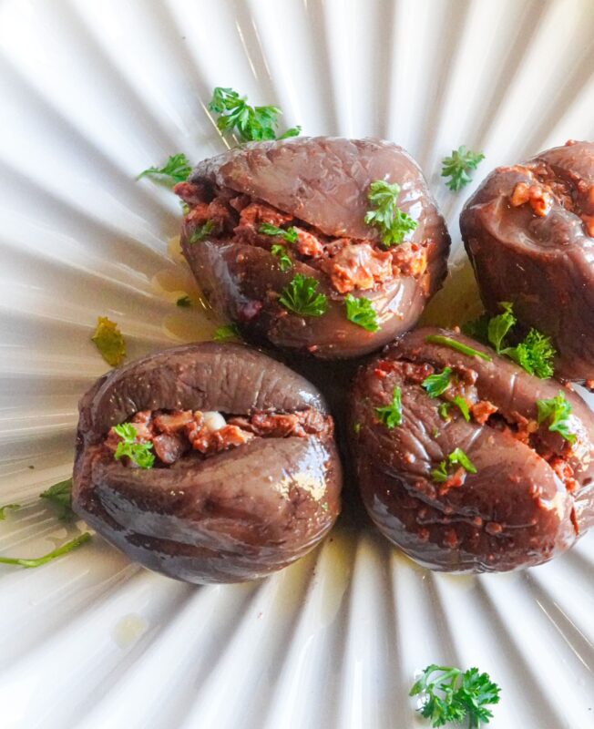 a plate of traditional makdous pickles sprinkled with finely chopped parsley.