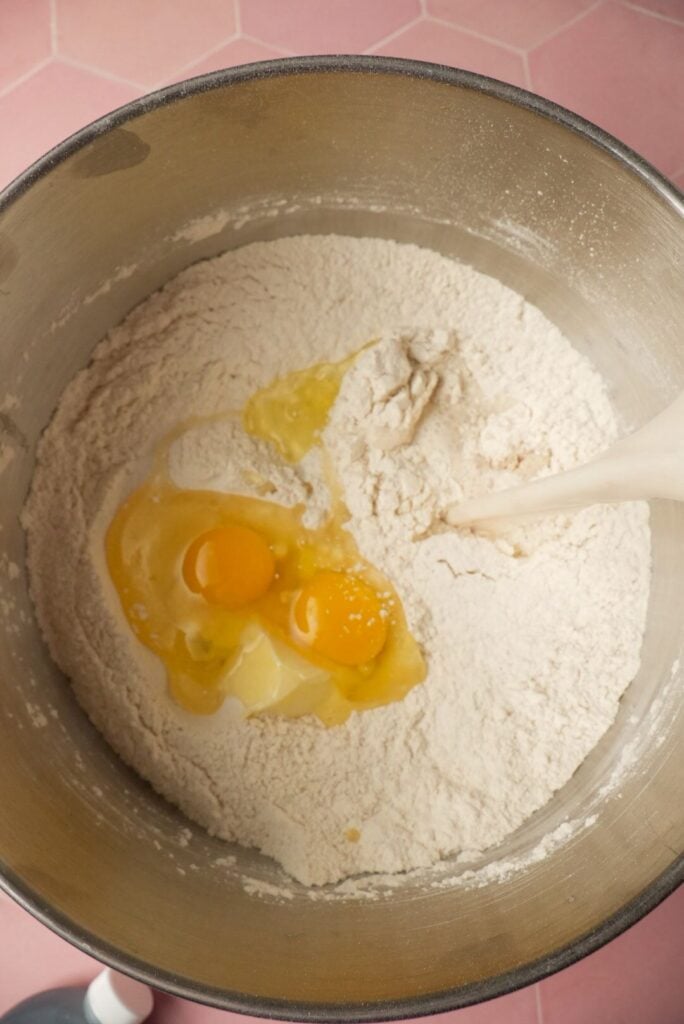 adding yogurt to the dough ingredients like eggs, flour, etc.